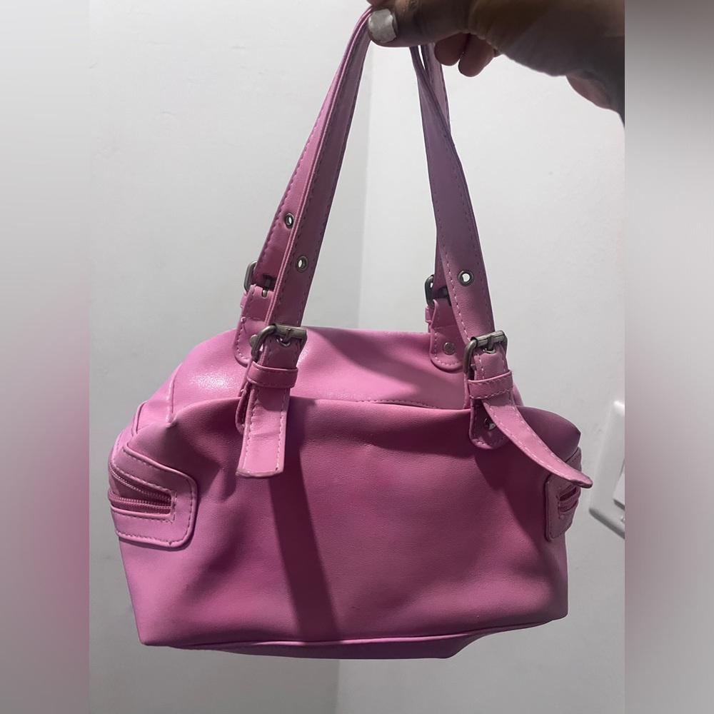 Pink leather bag with silver accents, with a zipper pocket and two side pockets